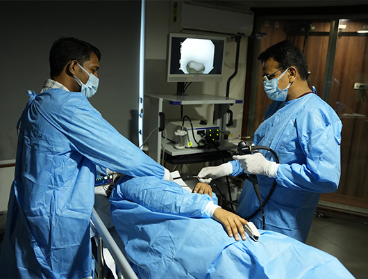 a doctor doing endoscopy treatment in calicut